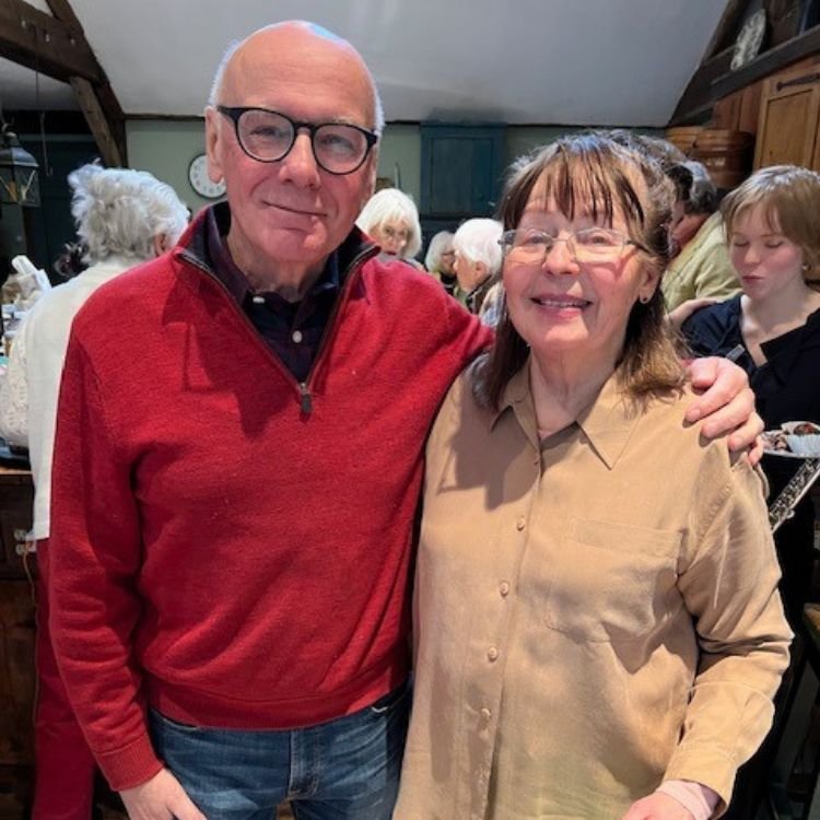 A former flute student now retired poses with Ginny following a music at the farm concert.